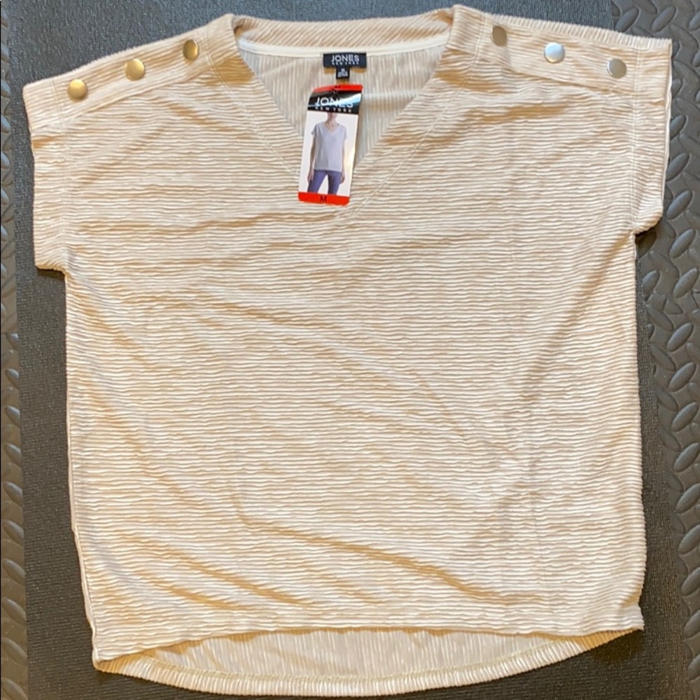 Sandstone top with bold buttons on shoulder